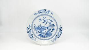 A large Chinese blue and white decorated glazed porcelain plate