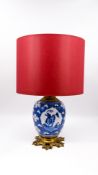 A Chinese blue and white decorated and glazed porcelain lamp vase on a bronze-mounted base