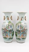 A Chinese pair of Qianjiang and Famille rose two-sided decorated porcelain vases with immortals