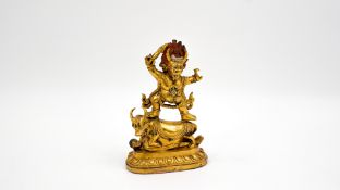 An antique Tibetan gilded bronze figurine of Yama Dharmaraja
