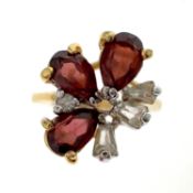 Garnet cluster ring. Set with pear-shaped garnets, inner hoop stamped 18k, ring size approx. P ½ ,