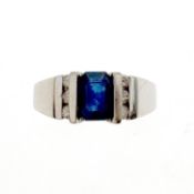 Sapphire and diamond ring. The emerald-cut sapphire between brilliant-cut diamond shoulders, inner