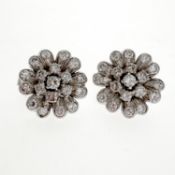 Diamond flower earrings. Each flowerhead set with European and brilliant-cut diamonds, diamonds