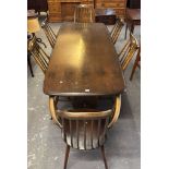 Mid-century Ercol elm and beech stained Refectory type dining table with six comb-back matching