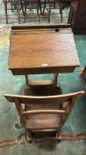 Early 20th century elm school type child's desk with integral correctional bar back chair. (B.P. 21%