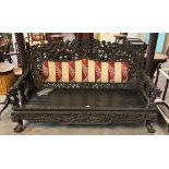 19th century heavily carved, stained and pierced Chinese sofa, overall decorated with entwined