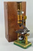 In the style of Carl Zeiss Jena, a lacquered brass microscope, on green finish metal stand, in