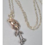 9ct rose gold pendant set with tiny diamonds on a silver gilt chain marked 925. (B.P. 21% + VAT)