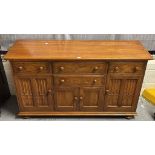 Mid 20th century Ercol elm sideboard with an arrangement of drawers and cupboards, two with