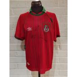 A Wales Umbro football top signed by Ian Rush, Ryan Giggs and John Charles, With COA by SA