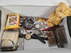Box of oddments to include: various dress watches, miniature teddy bear, Domino set, playing