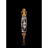 A ROMAN AGATE "DZI" BEAD WITH GOLD FILIGREE MOUNTS, CIRCA 1ST CENTURY A.D.