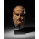 A CARVED BRONZE BUST OF KING SARGON OF AKKAD