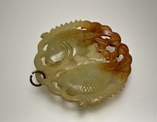 A modern Chinese celadon and russet jadeite pendant in the form of two carp: d. x 6cm