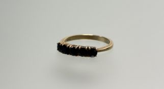A 9ct gold ring set five circular dark blue sapphires each stone approximately 0.20ct P 2.32g