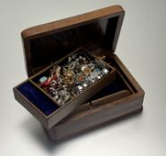 An eastern hardwood rectangular domed puzzle jewellery box containing a collection of costume
