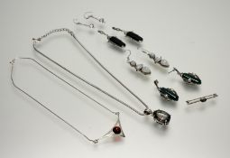 A collection of silver jewellery to include a green iridescent oval cut stone pendant on snake