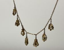 An Edwardian yellow metal chain necklace mounted seven baroque natural pearl drops: l. x 22cm 6.67g