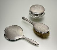 A Birmingham silver backed Art Deco dressing mirror: L. x 24cm and hair brush with natural
