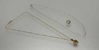 A 18ct gold heart-shaped pendant set emethyst with diamond point on 18ct gold trace link chain: