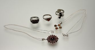 A collection of modern silver jewellery to include a triple row red stone set ring P/Q, a coil style