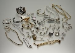 A collection of costume and silver jewellery to include a silver charm bracelet with a shoe,