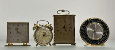 A vintage collection of four various brass cased table clocks to include a Looping square dial alarm