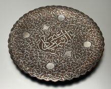 An early 20thc Middle Eastern copper white metal overlayed dish resting on three bun feet: h. x 05cm