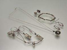 A collection of Charles Rennie MacIntosh silver-inspired jewellery to include a V-shaped necklace on