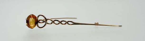 A 9ct gold double spiral kilt pin mounted oval faceted citrine approximately 3ct in claw setting: l.