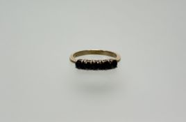 A 9ct gold ring set five circualr dark blue sapphires each stone approximately 0.20ct P 2.32g