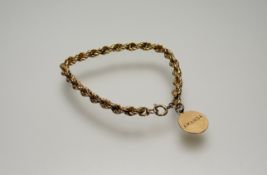 A 9ct gold rope pattern bracelet with ring fastening and 9ct gold disk engraved Amanda: d. x 8cm 6.