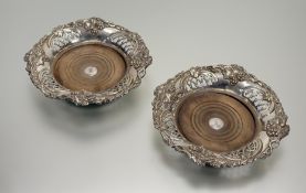A pair of impressive late 19thc Sheffield plated wine slides with pierced grape and vine leaf chased