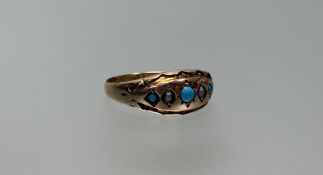 A Chester 9ct gold ring set three graduated turquoise cabouchon beads with two seed pearl spacers