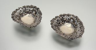 A pair of Victorian Birmingham silver heart-shaped ribbon and bow nut dishes with chased pierced