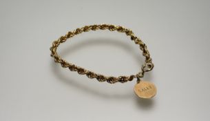 A 9ct gold rope pattern bracelet with ring fastening and 9ct gold disk engraved Sally: d. x 8.5cm