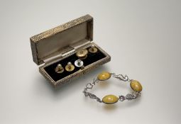 A sterling silver bracelet set three oval amber panels with seahorse links and ring fastening: d.