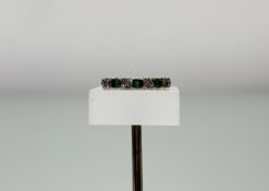 A 9ct gold ring set three round cut emeralds flanked by four diamond points N 2.29g