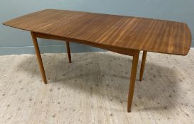 A mid-century teak extendable dining table, shaped top with moulded edges and extra leaf, raised