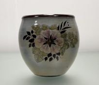 A Chelsea Pottery Plant Pot, in a typical floral design by JC, marked verso. (h-21cm w-18cm)