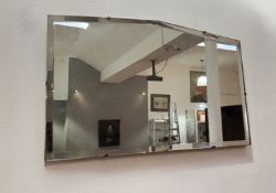 An Art Deco octagonal mirror with bevelled edge and mounting chain (l. 53.5cm x h. 34cm)