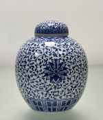 A late 19thc/20thc Chinese blue and white ginger jar, in scrolling design with flower to centre, two