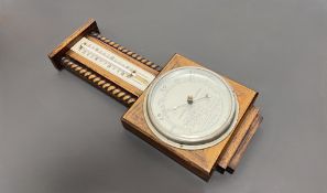 A British made Mid-Century barometer and thermometer with mahogany casing and turned wooden rope