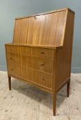 A mid-century teak bureau, with fall-front revealing fitted interior and inset writing surface, over