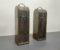 A pair of stained wooden wine bottle carriers, each decorated to the front with embossed sheet metal