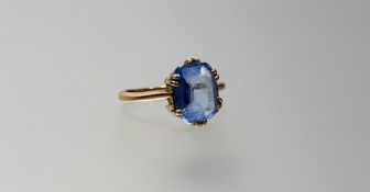 A yellow metal ring set cushion cut zircon in six claw setting wear and chips to table and edge N/