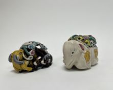 A pair of Chinese glazed ceramic temple figures, one decorated with two rams and a yin-yan symbol to