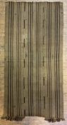 A Turkish flat-woven kilim rug, made up of striped panels in earth tones, with tassels to one end: