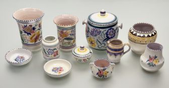 A collection of Poole Pottery all decorated in the typical floral and geometric shape design