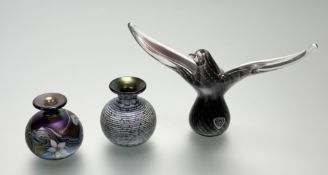 An Okra Studio glass small bud vases, one in a cream with lustre purple and blue pattern (h-8.5cm)